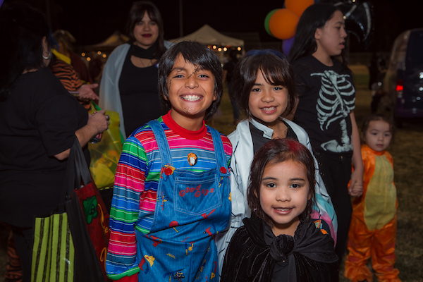 Three kids wearing costumes