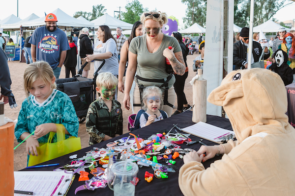 Kids collecting giveaways at a table