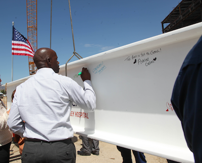 People signing the steel beam for the new patient tower